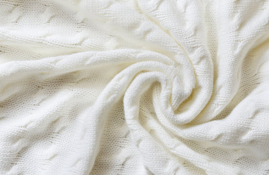 Crumpled white knitted blanket