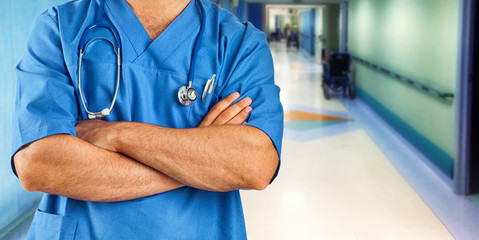 Nurse or doctor with blue jacket in the hospital ward.