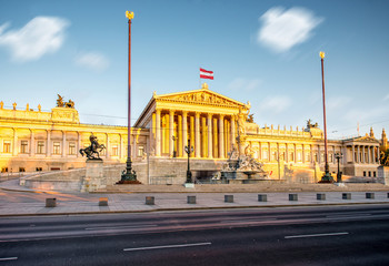 Austrian parliament building with Athena statue on the front in Vienna on the sunrise. Long exposure image technic with burred clouds