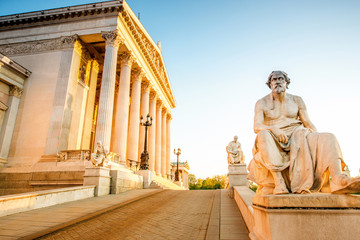 Austrian parliament building with statue on the front in Vienna on the sunrise
