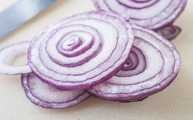 Sliced fresh red onion isolated on white background