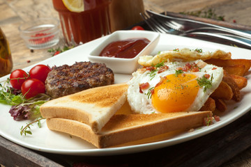 Minced beef on the grill with  fried eggs, crisp and toast.