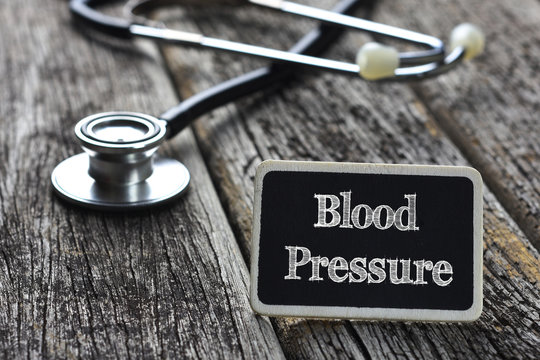 Medical Concept- Blood Pressure word written on blackboard with