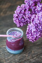 Blueberry smoothie in small glasses on a wooden  table