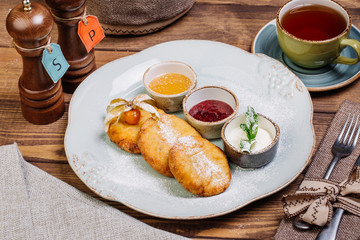 Homemade delicious cottage cheese pancakes with jam and honey 