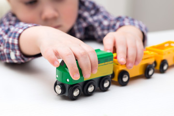 boy playing with a green train