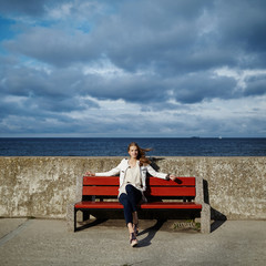 Fototapeta premium beautiful blonde woman sitting on bench