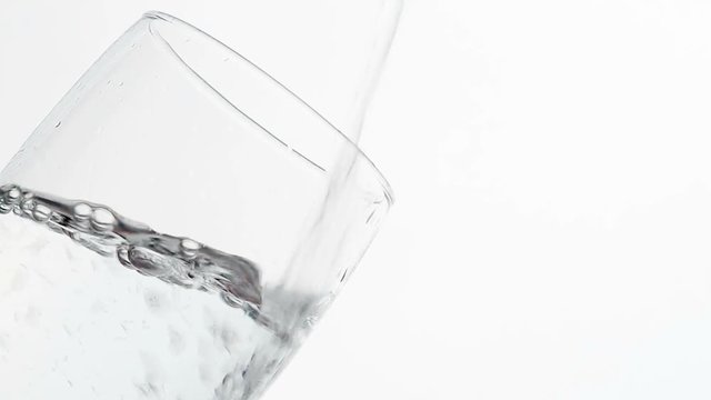 Close Up of water pouring into a glass. 