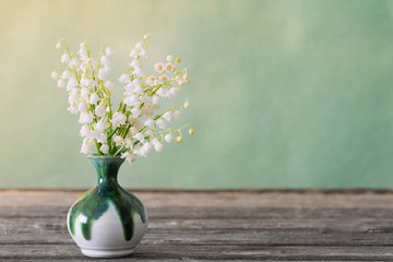 Lilly of valley in  vase on wooden table