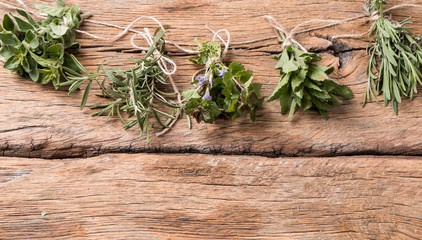 Herbs on wooden background. Mint, thyme, balm and other medicinal herbs