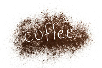 The word coffee written against scattered natural coffee isolated on a white background