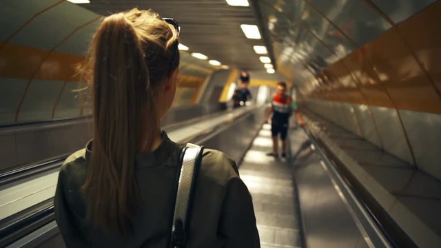 couple going down the subway on the escalator slow motion