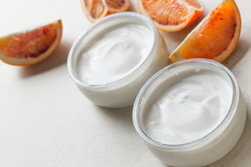 Yogurts assortment  in glass bowls on wooden light background. Natural and fruit  healthy, diet, gourmet dessert for granola breakfast. Sweet yoghurts closeup.