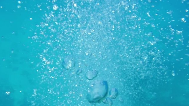 Underwater, high angle shot over a billion water bubbles they works its way to the surface. Shot taken in the real sea environment.
