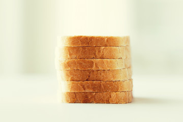 close up of white sliced toast bread pile on table