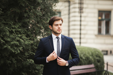 Handsome stylish young businessman posing portrait outdoor