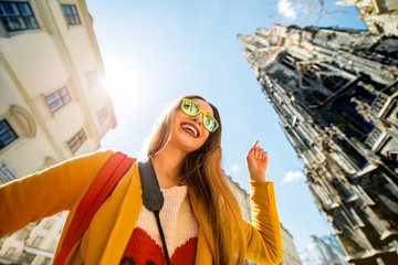 Young smiling woman pointing on St. Stephen's Cathedral in Vienna