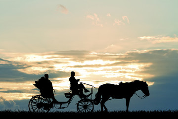 couple on carriage ride at sunset