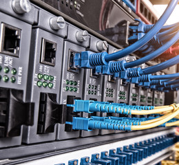 Fiber Optic cables connected to an optic ports and Network cable