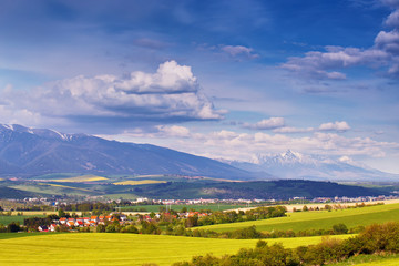 Town and green spring hills in Slovakia. May sunny countryside