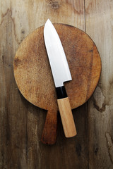 japanese Knife on a cutting board on a wooden table