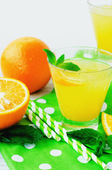 
detox , healthy and refreshing drink, juice or lemonade, Nutritious cold sparkling water with fresh green mint and orange in the jar on a wooden background
