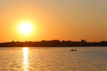  kayaking on lake at sunset