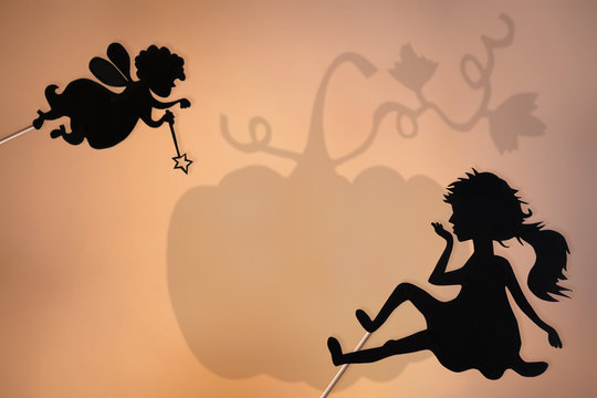 Fairy Godmother, Cinderella and Pumpkin shadow puppets, copy space background