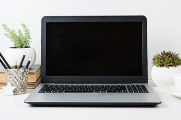 Fototapeta premium modern work space with laptop mockup on a table