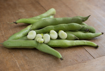 Broad beans on a wooden surface