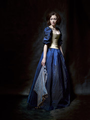 Beautiful girl wearing a medieval dress. Studio works inspired by Caravaggio. Cris. XVII