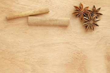 Cinnamon sticks and star anise on a wooden table.