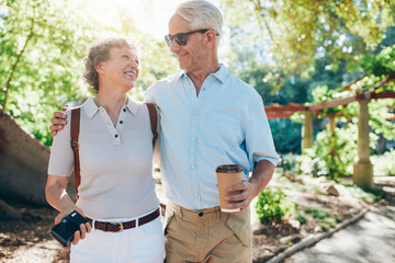 Loving mature couple walking together in a park - Powered by Adobe