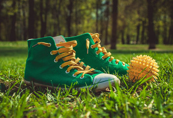 Green sneakers and yellow ball