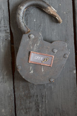 Open sign and old padlock 