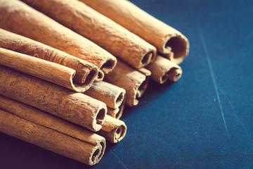Bunch of cinnamon sticks on black background