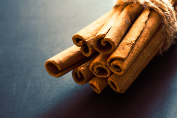 Bunch of cinnamon sticks on black background