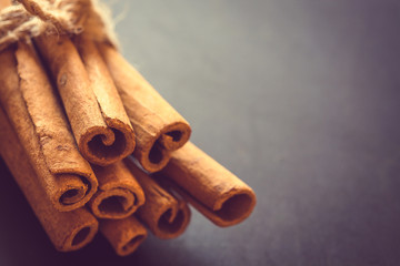 Bunch of cinnamon sticks on black background