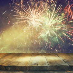 wooden table in front of blurred fireworks background