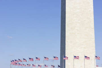 The Washington Monument & American flagpoles in a circle around the perimeter of the national monument plaza, Washington DC
