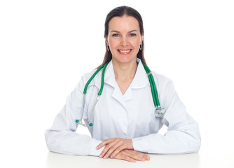 Fototapeta premium Beautiful smiling female doctor sitting at the desk. Isolated