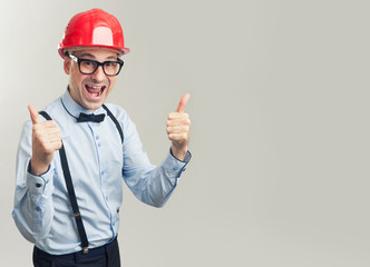 Man in construction helmet showing thumbs up