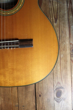 Acoustic guitar on the background of wood