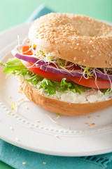 tomato sandwich on bagel with cream cheese onion lettuce alfalfa