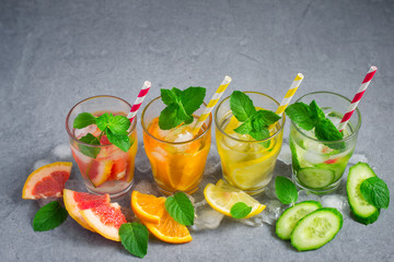 Refreshing summer drinks water with ice and lemon, orange, grape