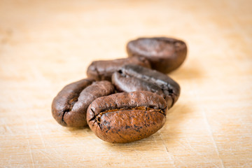 Roasted coffee beans on wooden background, Macro