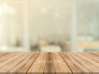 Wooden board empty table in front of blurred background. Perspective brown wood over blur in coffee...