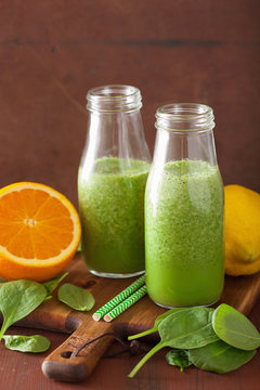 healthy green spinach smoothie with lemon orange
