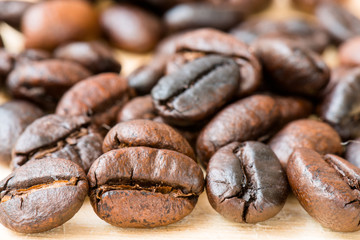Roasted coffee beans on wooden background, Macro