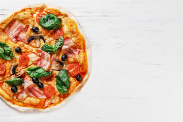 Top view of Italian PIZZA with mushrooms, basil, tomato, olives and cheese and bacon. WITHOUT one piece.  white wooden table background. Look as Prosciutto, Capricciosa, Funghi, Cotto PIZZA. 